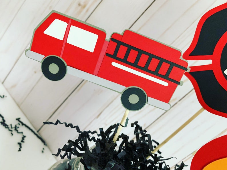 firefighter centerpiece birthday decorations featuring a firetruck, emblem with age, flame, fire hydrant, dalmatian and fire extinguisher