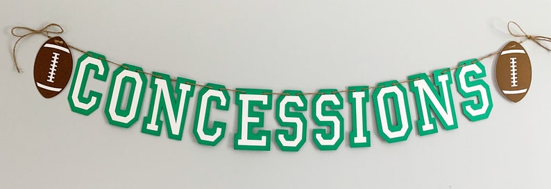 football concessions banner featuring varsity letters and two footballs that will be perfect for your little one's football themed birthday party, super bowl game day party, sports team party or to hang on your schools concession stand during football season. The banner is fully customizable.