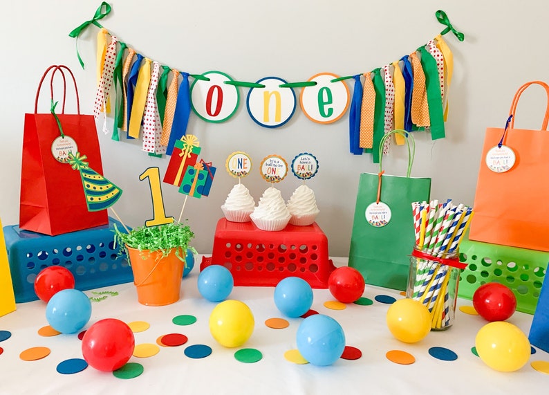Let's have a ball, It's a ball to be one high chair banner featuring primary colors