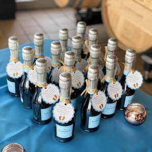 pink and gold baby shower favor tags for mini champagne bottles