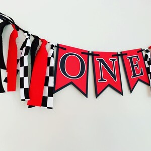 red  and black racing themed high chair one banner featuring checkered flag fabric