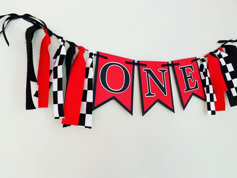 red  and black racing themed high chair one banner featuring checkered flag fabric