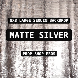 May include: A large matte silver sequin backdrop featuring vertical rows of shimmering sequins. The text 8X8 LARGE SEQUIN BACKDROP, MATTE SILVER, and PROP SHOP PROS is displayed in black rectangular boxes centered on the fabric surface.