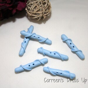 May include: Five light blue plastic buttons shaped like a twisted vine. Each button has two holes and a textured surface.