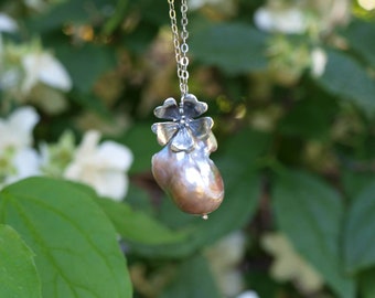 Long silver necklace with large pink drop baroque pearl and rosehip flower in burnished silver