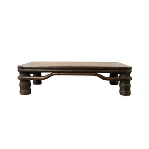 May include: A dark brown wooden table with a rectangular top and four legs. The legs are carved in a cylindrical shape with a decorative design.