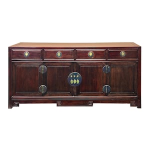 May include: A dark wood cabinet with four drawers and four doors. The cabinet has brass hardware and a rectangular shape. The wood has a rich, reddish-brown color. The cabinet is a piece of furniture.