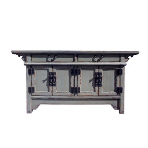 May include: A gray wooden cabinet with two drawers and four doors. The cabinet has black metal hinges and handles. The cabinet has a distressed finish.