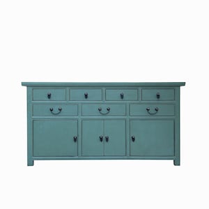 May include: A teal blue wooden dresser with eight drawers and three doors. The dresser has black metal handles.