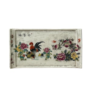 May include: A rectangular ceramic tray with a white base featuring a colorful hand-painted scene of a rooster, vibrant pink and yellow peonies, and a peach tree. Black Chinese calligraphy characters are inscribed in the upper left corner.
