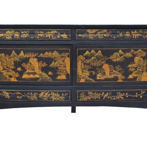 May include: Black wooden cabinet with gold painted landscape scenes and floral designs. The cabinet has two doors and two drawers.