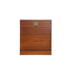 May include: A wooden box with a brass latch. The box is a dark reddish brown color and has a wood grain pattern.