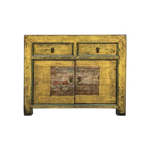 May include: A yellow painted antique cabinet with two drawers and two doors. The cabinet has a distressed finish and features a painted design on the doors.