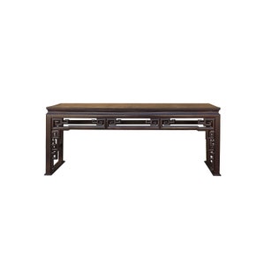 May include: A dark brown wooden table with intricate carved details on the legs and apron. The table has a rectangular top and a simple, elegant design.