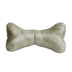May include: A light green bone-shaped pillow made of satin fabric.