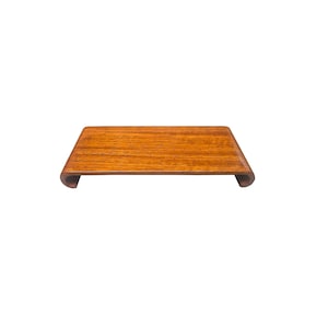 May include: A wooden tray with a curved edge and a natural wood finish.