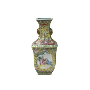 May include: A yellow, rectangular vase with a square top and two gold-coloured handles. The vase features a detailed floral and landscape design with a central panel depicting figures in a garden setting. The vase is approximately 30 cm tall.