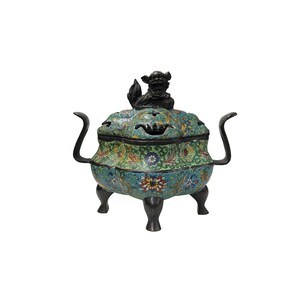 May include: A decorative, antique-style incense burner with a floral pattern in shades of green, blue, yellow, and red. The lid is topped with a black, stylized lion figure. The burner has curved handles and rests on three short legs.