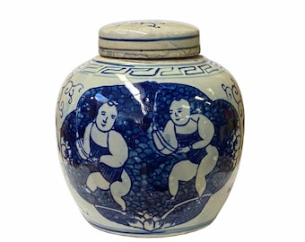 May include: A white porcelain jar with a blue and white design of two children playing. The jar has a lid and is decorated with a traditional Chinese pattern.