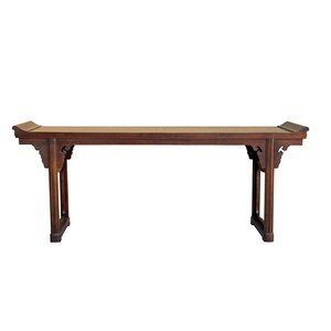 May include: A dark brown wooden table with intricate carvings on the legs and a slightly curved top.