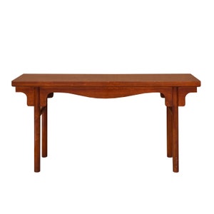May include: A dark brown wooden console table with a curved top and four legs. The table has a simple, elegant design.