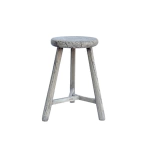 May include: A rustic wooden stool with a round seat and three legs. The stool is made of weathered wood and has a natural gray finish.