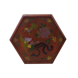 May include: Hexagonal red box with a painted floral and bird design. The box features a phoenix and purple flowers, with green and yellow accents. The box has a dark red border.