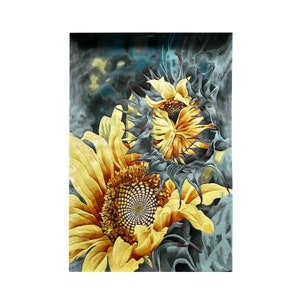 May include: A close-up of two sunflowers with yellow petals and brown centers. The sunflowers are against a dark blue and gray background.