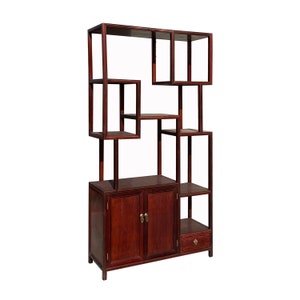 May include: A dark wood bookshelf with a cabinet and a drawer. The bookshelf has multiple shelves and open compartments, creating a unique and decorative design.