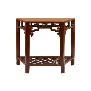 May include: A semi-circular wooden console table with a dark reddish-brown finish. The table features four straight legs, an openwork lattice shelf at the base, and decorative carved brackets under the top surface with intricate detailing.