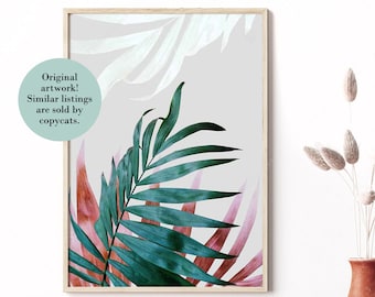 May include: A framed print of a tropical leaf design with green and pink leaves on a light gray background. The text "Original artwork! Similar listings are sold by copycats." is in a circle at the top left of the print.