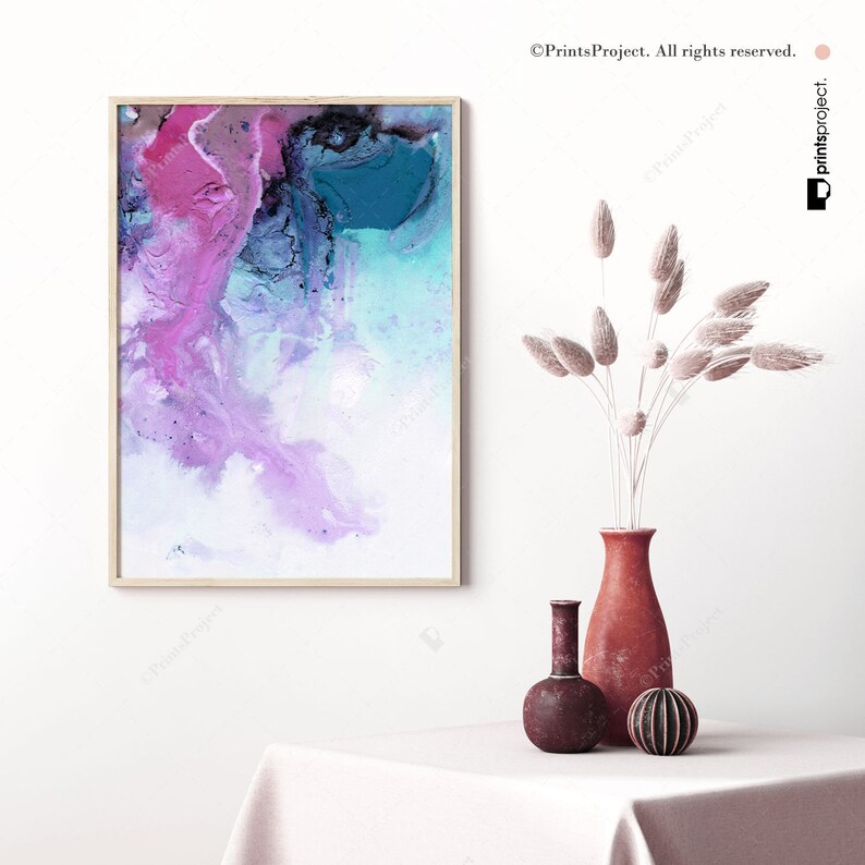 May include: Abstract painting in shades of pink, blue, and white in a wooden frame. The painting is hanging on a white wall above a table with a vase of dried flowers and two decorative vases.