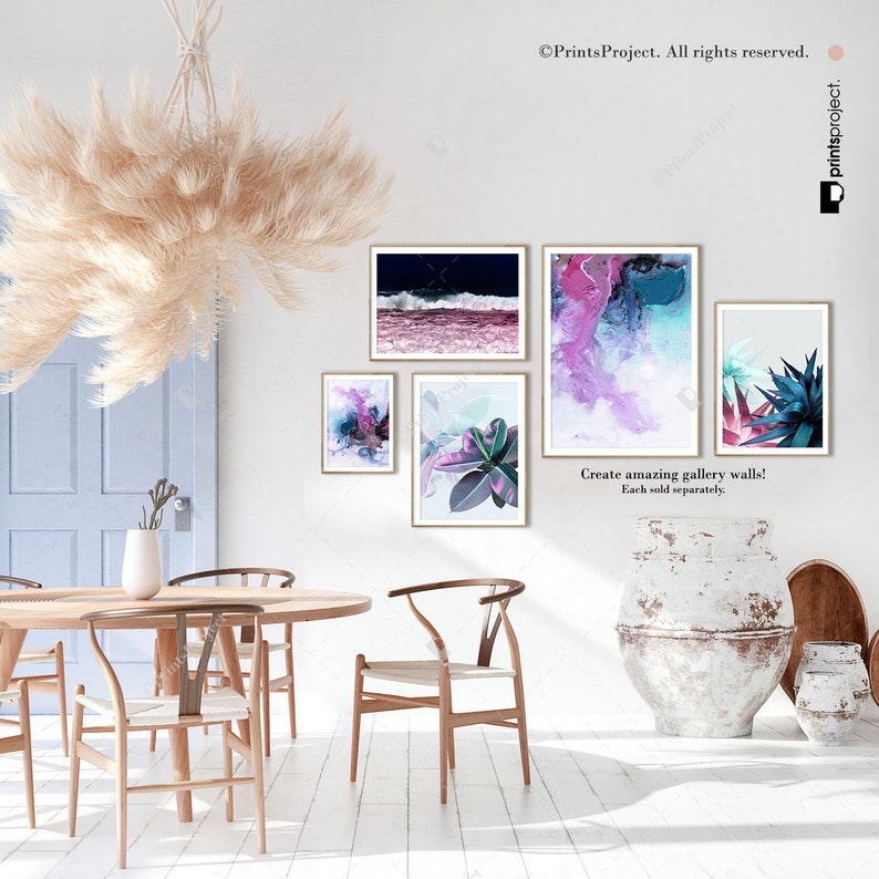 May include: A set of four abstract art prints featuring a variety of colors and textures. The prints are displayed on a white wall in a dining room setting with a wooden table and chairs.