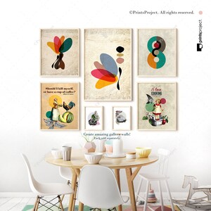 May include: A set of six framed prints with various designs, including abstract shapes, a woman with a rooster, a girl cooking, and a quote about coffee. The prints are arranged on a wall above a wooden table with chairs.