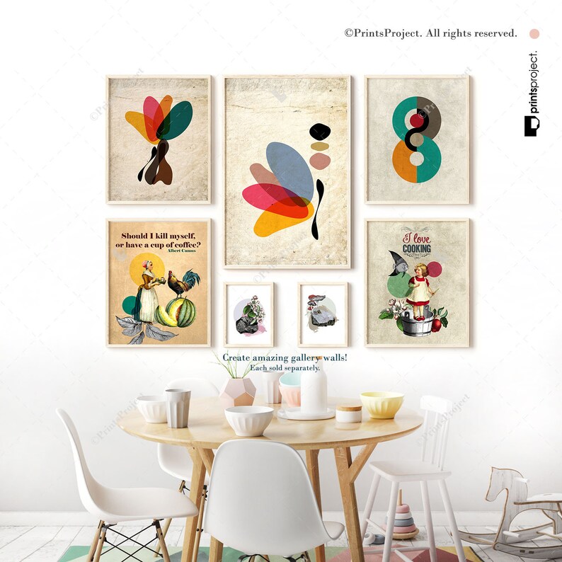 May include: A set of six framed prints with various designs, including abstract shapes, a woman with a rooster, a girl cooking, and a quote about coffee. The prints are arranged on a wall above a wooden table with chairs.
