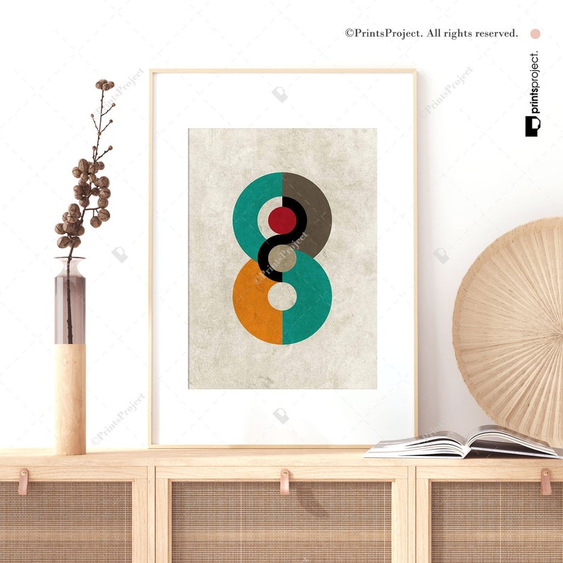 May include: A framed print of an abstract design featuring overlapping circles in shades of orange, teal, gray, red, and white on a textured beige background.