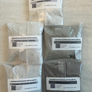 May include: Five clear plastic bags containing Mapei Ultracolor Plus FA grout powder in various shades of gray. The labels specify the colors Frost #5077, Warm Gray #5093, Pewter #5002, Cobblestone #5103, and Gray #5009, with a 1 oz water to 4 oz mix ratio.