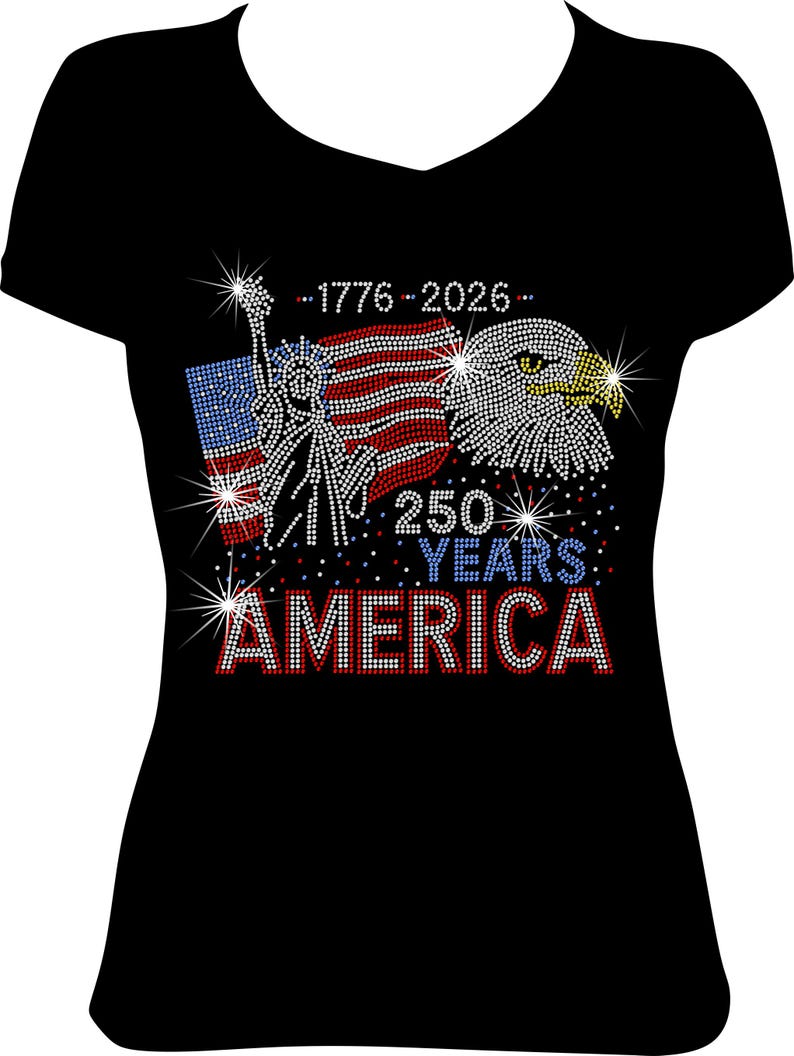 May include: Black V-neck t-shirt with a patriotic design. The design features the Statue of Liberty, an American flag, and an eagle, all embellished with sparkling rhinestones. Text includes "1776-2026" and "250 YEARS AMERICA."