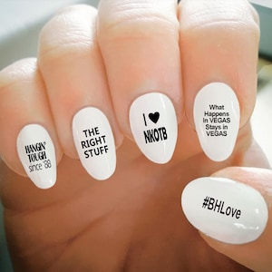 May include: White nail art with black text. The nails display phrases like "HANGIN' TOUGH since '88", "THE RIGHT STUFF", "I ♥ NKOTB", "What Happens In VEGAS Stays in VEGAS", and "#BHLove".