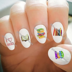 May include: Nail art stickers with a book theme. The stickers feature a stack of books, a single open book, a heart with the words "I love books", and the word "Read" in colorful letters.