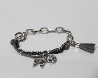 toggle bracelet with wing charm and tassel