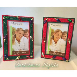 May include: Two red and green picture frames decorated with Christmas light bulbs. The frames have a green border and are adorned with colorful light bulb accents. Each frame holds a photo and the text "Acrylic Frame" is visible.