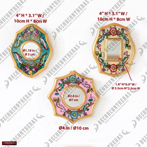May include: Three decorative mirrors with colorful floral designs. The mirrors have gold-colored frames and come in various shapes: an octagon, a rounded rectangle, and a star. The dimensions are provided in inches and centimeters.