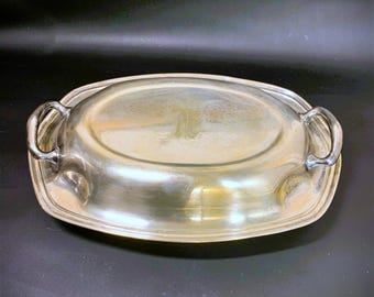 May include: A silver oval serving dish with a lid and two handles. The lid has a monogrammed initial.