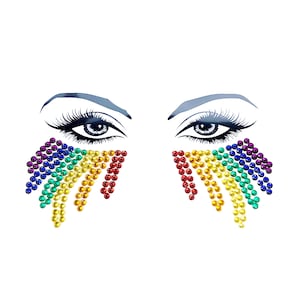 May include: Rainbow coloured face jewels in the shape of a teardrop. The jewels are arranged in a rainbow pattern, with red at the top and purple at the bottom.