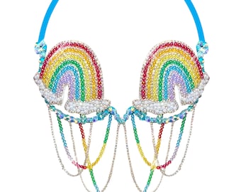 May include: A rainbow-colored beaded bra with a chain detail. The bra is made of small, iridescent beads that are arranged in the shape of a rainbow. The bra has a chain detail that hangs from the bottom of the bra.