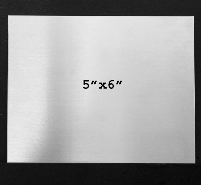 May include: A brushed silver metal sheet with the dimensions 5" x 6" printed on it.