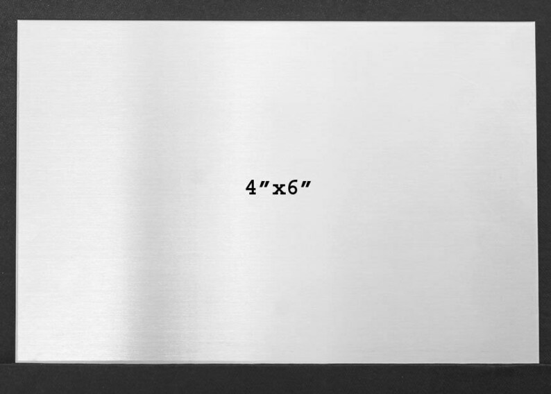 May include: A blank, silver, rectangular metal sheet with the text "4" x 6" printed in black.