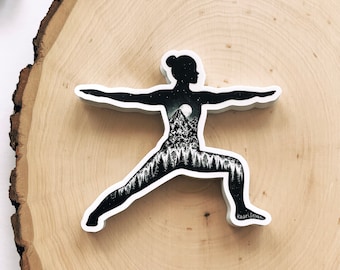 May include: Black and white silhouette of a person in a yoga pose with a mountain range and moon inside the silhouette. The text "Kalari Seven" is at the bottom of the image.