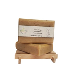 May include: A stack of two handmade ginger orange soap bars with turmeric, labeled "BEAUTY BY FRANCESCA", "Ginger Orange w/Turmeric Handmade Soap", and "Net Wt. 4 oz. (113 g)".